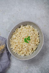 Bowl of cooked Whole grain brown rice  on wooden background overhead view