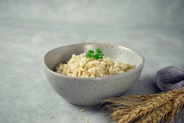 Bowl of cooked Whole grain brown rice  on wooden background overhead view