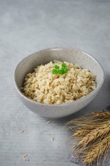 Bowl of cooked Whole grain brown rice  on wooden background overhead view