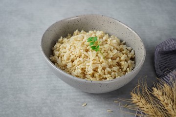 Bowl of cooked Whole grain brown rice  on wooden background overhead view