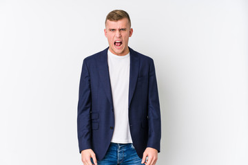 Young business caucasian man screaming very angry and aggressive.