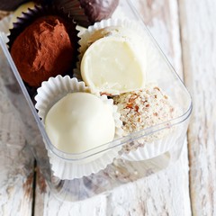 Chocolate truffles in a glass box on a white vintage background. Homemade fresh energy balls. Valentine's Day Gift, Birthday
