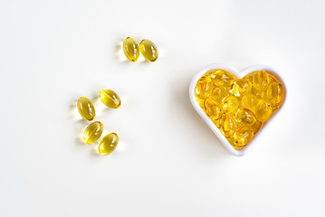 Omega-3 fish oil capsules in the shape of a heart for the cardiovascular system of the body. View...