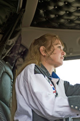 Woman Truck Driver Watching Traffic Ahead of Her