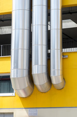 heating system or utility lines on a building. The pipes of the service system on the roof are covered with a galvanized steel cover.