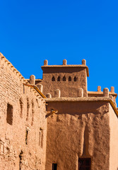 View of the facade of a building in Ait-Ben-Haddou, Morocco. Vertical. Isolated on blue background.