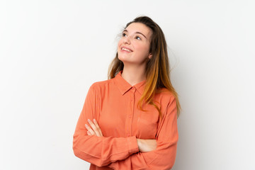 Obraz premium Young brunette girl over isolated white background looking up while smiling