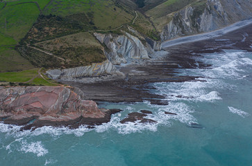 Zumaia and Algorri flysch geological strata layers drone aerial view panorama, Basque Country