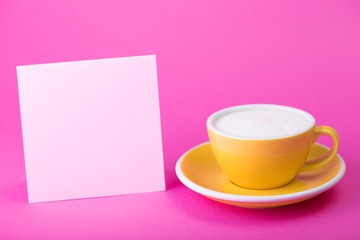 yellow cup on a pink  background