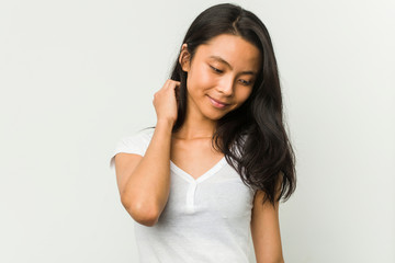Young chinese woman posing on a white background