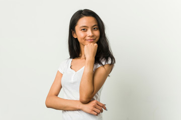 Young chinese woman posing on a white background