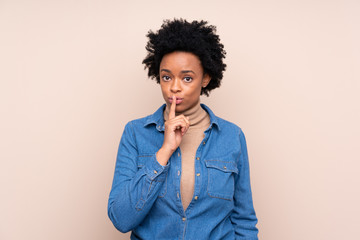 African american woman over isolated background doing silence gesture