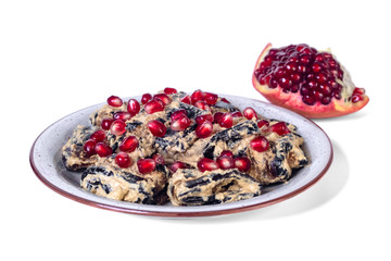 Traditional georgian eggplant dish with walnut and pomegranate on the plate.