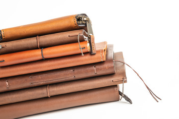 A Stack Of Leather-Bound Journals, Notebooks, Wallets & Cases