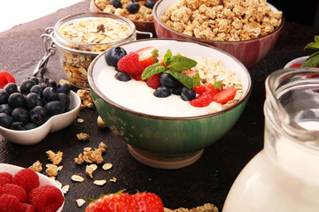 Tasty homemade granola served on table. Healthy breakfast with a bowl of oatmeal with banana, blueberries, strawberries and healthy food for Breakfast