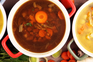 Set of soups from worldwide cuisines, healthy food. Broth with noodles, beef soup and broth with marrow dumplings. All soups with healthy vegetables on table