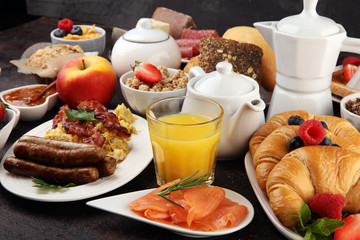 Breakfast served with coffee, orange juice, croissants, cereals and fruits. Balanced diet. Continental breakfast with granola and fruits