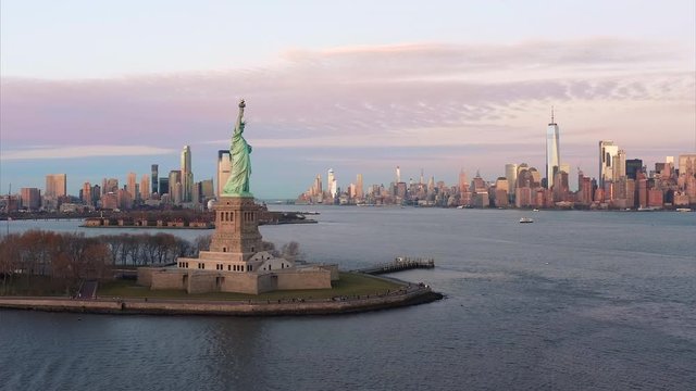 Aerial view of Statue of Liberty with Manhattan skyline and Jersey City Skyline in 4K