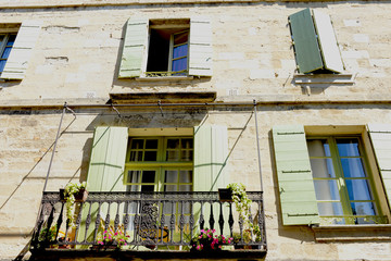 Fototapeta na wymiar mediterranean facade with green wooden shutters