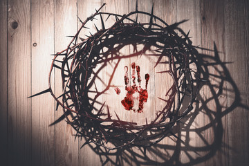 Crown of thorns and hand print in blood