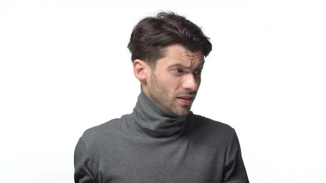 Problematic situation. Slow-motion indecisive puzzled and confused handsome bearded male in turtleneck, shaking hands dismay, frustrated, cant undertstand, standing clueless white background