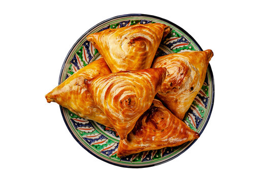Uzbek national oriental cuisine. Samsa with meat on a wooden background. Background image. Copy space.