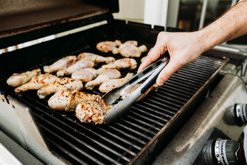 Delicious Seasoned Chicken Drumsticks On The Grill Being Flipped, Grilling Chicken