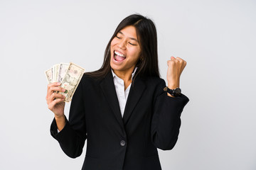 Young chinese business woman holding money isolated