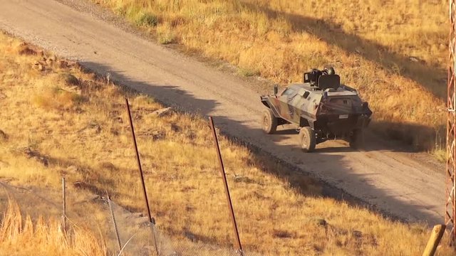 Turkey, Iraq border, 7/6/2016, turkish armoured attack truck cobra passing through between yellow grass