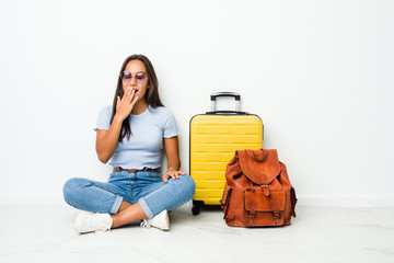 Young mixed race indian woman ready to go to travel yawning showing a tired gesture covering mouth with hand.