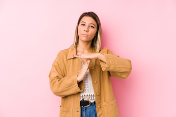 young caucasian woman posing isolated showing a timeout gesture.