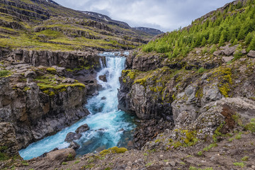 Fototapeta na wymiar View on the Sveinsstekksfoss waterfall in eastern Iceland