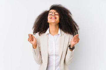 Young african american business woman raising fist, feeling happy and successful. Victory concept.