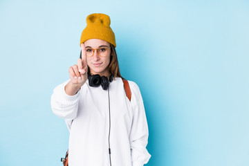 Young caucasian woman with earphones isolated showing number one with finger.