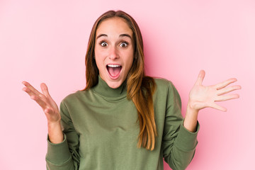 Young caucasian woman posing isolated  celebrating a victory or success, he is surprised and shocked.