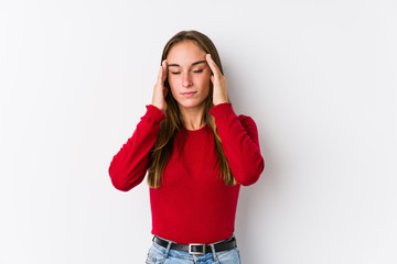 Young caucasian woman posing isolated  touching temples and having headache.