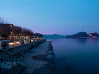 nightscape Arona lakefront and Lombardy side with the castle in Angera.winter landscape lake maggiore,Italy.