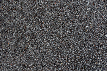 blue poppy seeds background. Natural seasoning texture. Food ingredient.