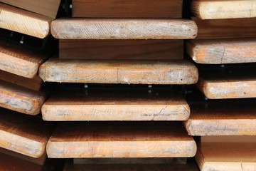 close up of a stack from Folded wood party tables and benches