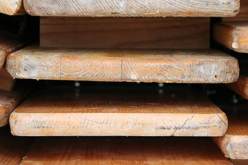 close up of a stack from Folded wood party tables and benches