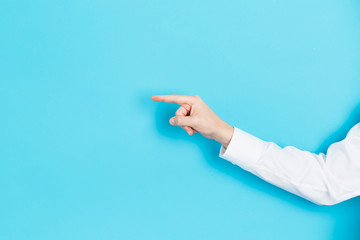 Businessman pointing his finger on a blue background