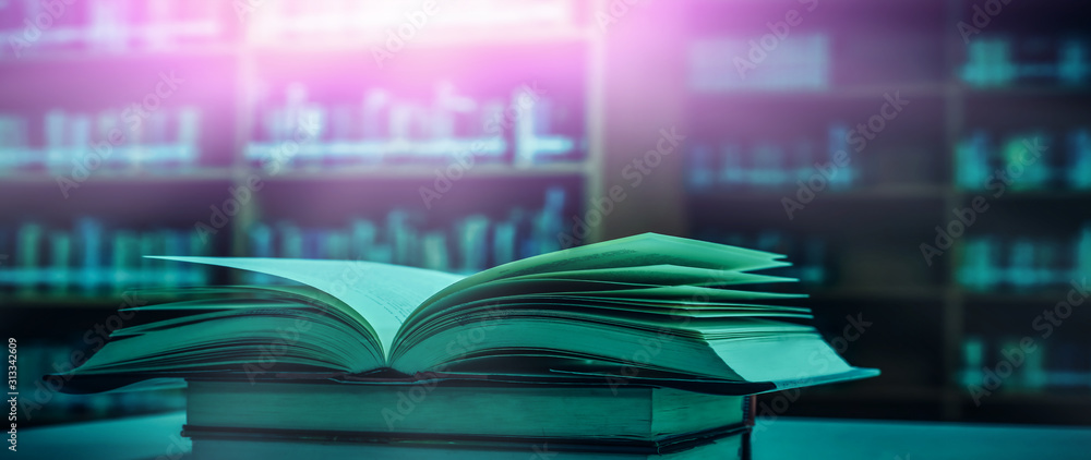 Poster stack of books in the library and blur bookshelf background