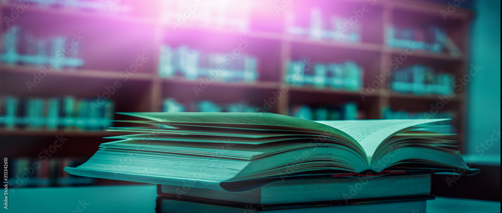 Poster stack of books in the library and blur bookshelf background