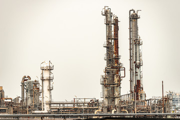 Fototapeta premium Refinery factory oil storage tank and pipeline steel on a over cast day