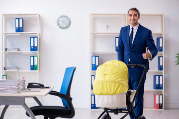 Young father looking after newborn in the office