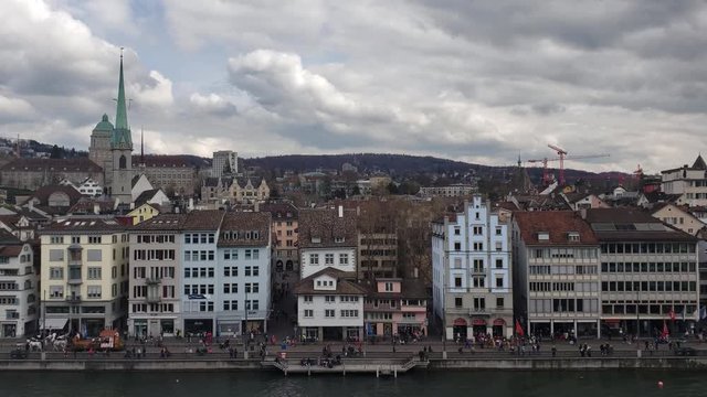 Zurich, Switzerland - April, 2019 - Tilt up from the Limmat River to the Altstadt (Oldtown) Skyline.