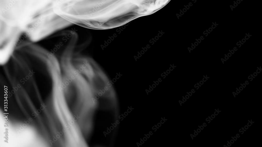 Wall mural plumes of real white smoke on a half frame on a contrasting black background. the concept of transit