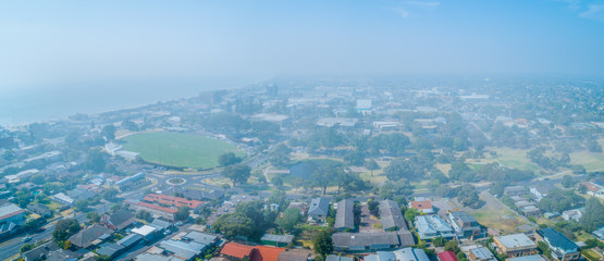 Aerial panorama of Melbourne suburbs covered in smoke haze from bush fires in Gippsland