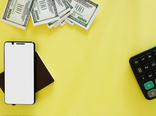 A white screen smartphone with a $ 100 bank note on a yellow background