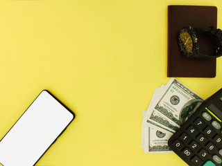 White screen smartphone with a top $ 100 bank note and a yellow background calculator top view